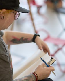 A woman with a pencil and drawing pad A woman with a pencil and drawing pad