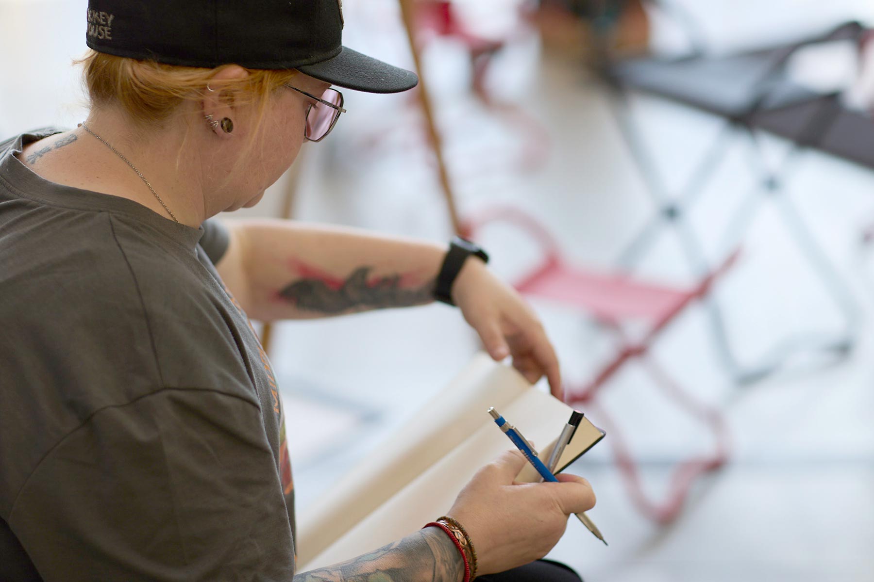 A woman with a pencil and drawing pad