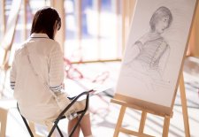 Drawing on paper at an easel in the Gordon Darling Hall