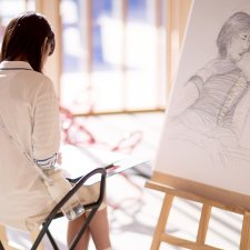 Drawing on paper at an easel in the Gordon Darling Hall