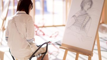 Drawing on paper at an easel in the Gordon Darling Hall