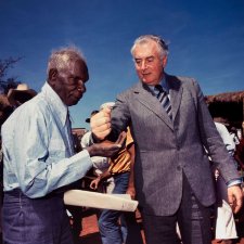 Prime Minister Gough Whitlam pours soil into the hand of traditional land owner Vincent Lingiari