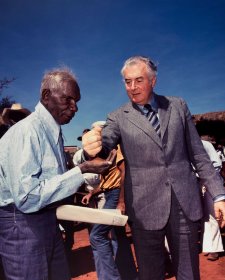 Prime Minister Gough Whitlam pours soil into the hand of traditional land owner Vincent Lingiari