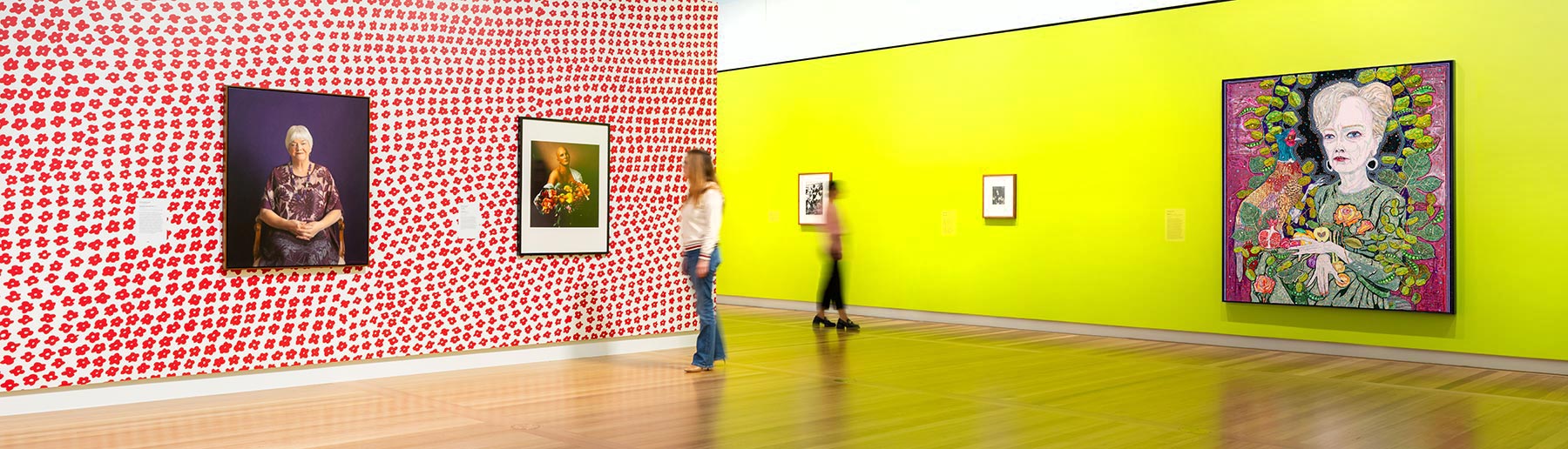 Two people looking at artworks