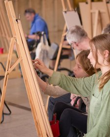 People drawing at easels in the Gordon Darling Hall